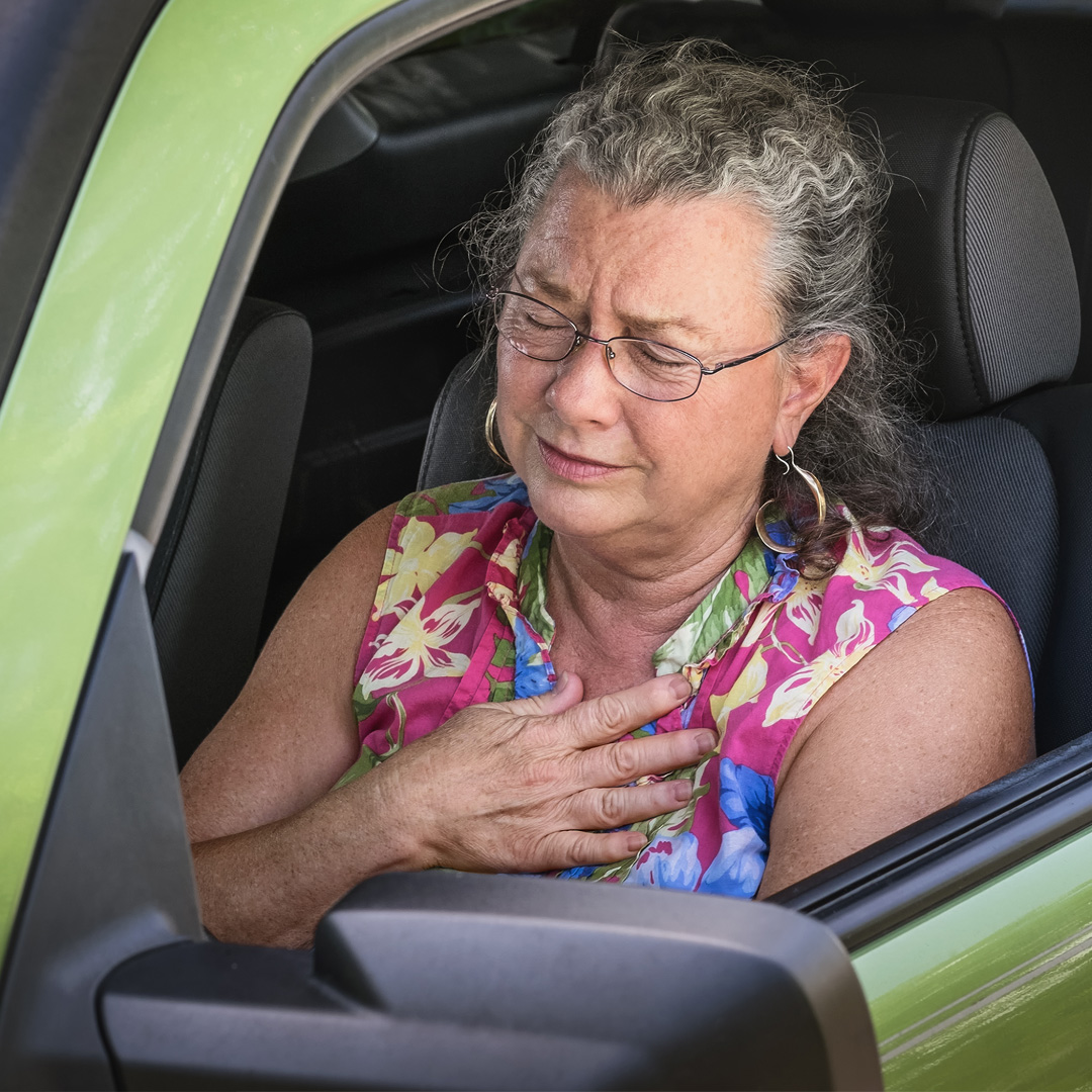 woman in car realizing she is feeling too hot